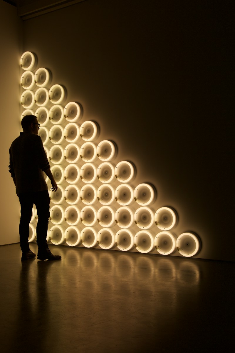 silhouette photo of man standing in front of LED wall lights 